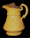 Image of a yellow relief molded jug showing the Tam-O-Shanter pattern. (Private collection)